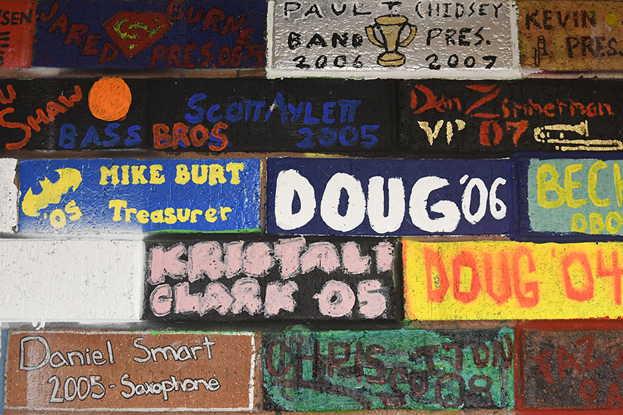 Painted bricks in the band room a reminders of memories from graduates from many years.