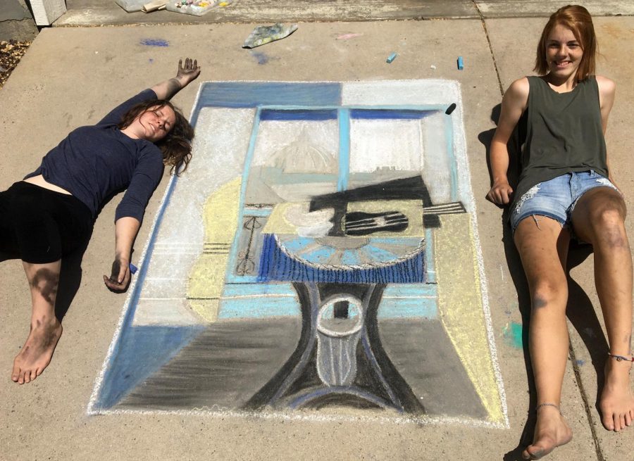 Emma and Hannah Cecil proudly display their chalk the walk art. 