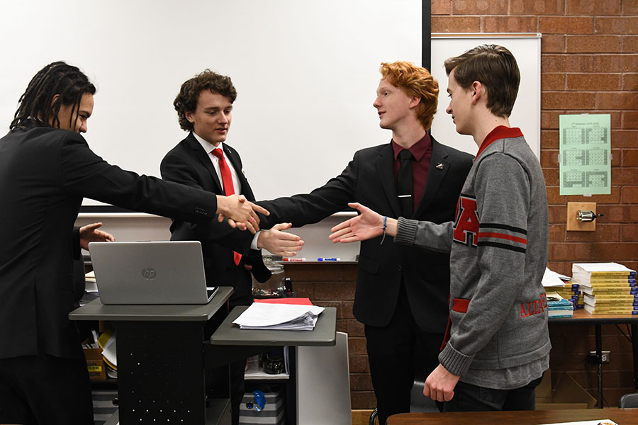 Davidson Pierson, Ian Whatley, Daniel Ross, and Gage Jeppson pose for a mock debate photo.