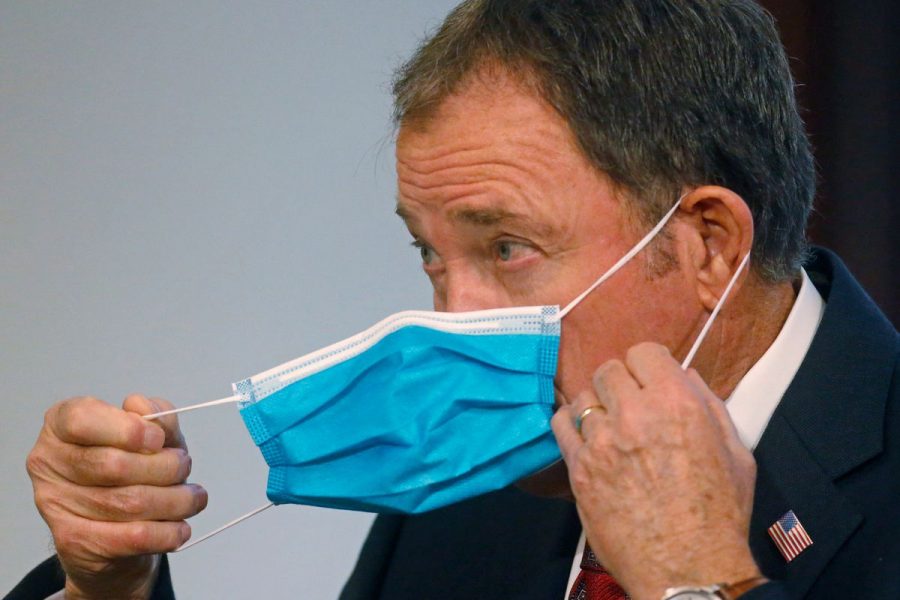 Governor+Gary+Herbert+demonstrates+the+ease+of+wearing+face+masks+in+public+to+deter+the+spread+of+Covid-19.