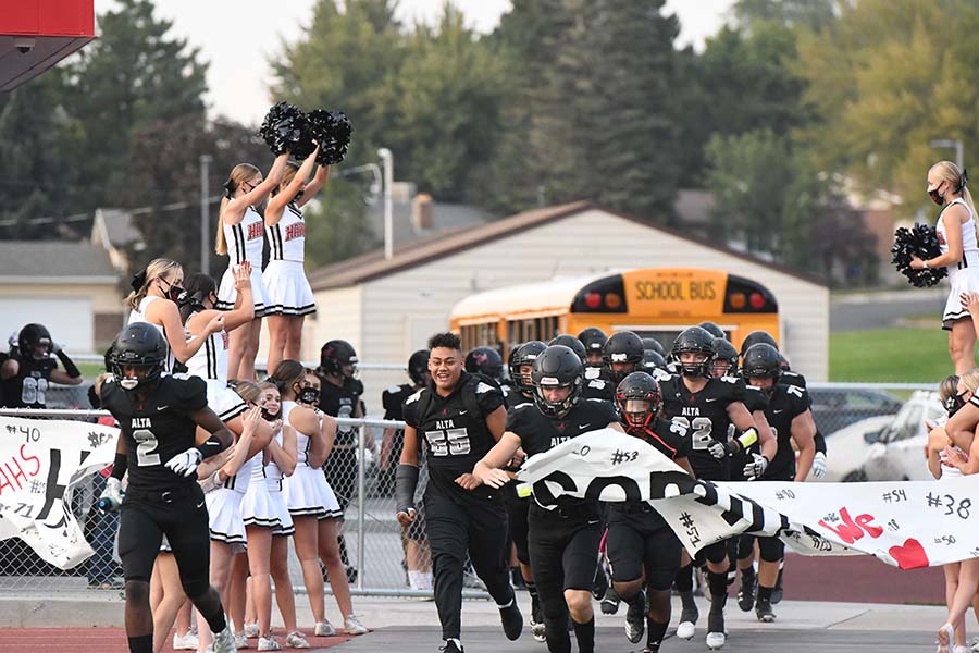 Fottball players rush onto the field in preparation for their Homecoming game with Timpanogos. Alta won 56-13.