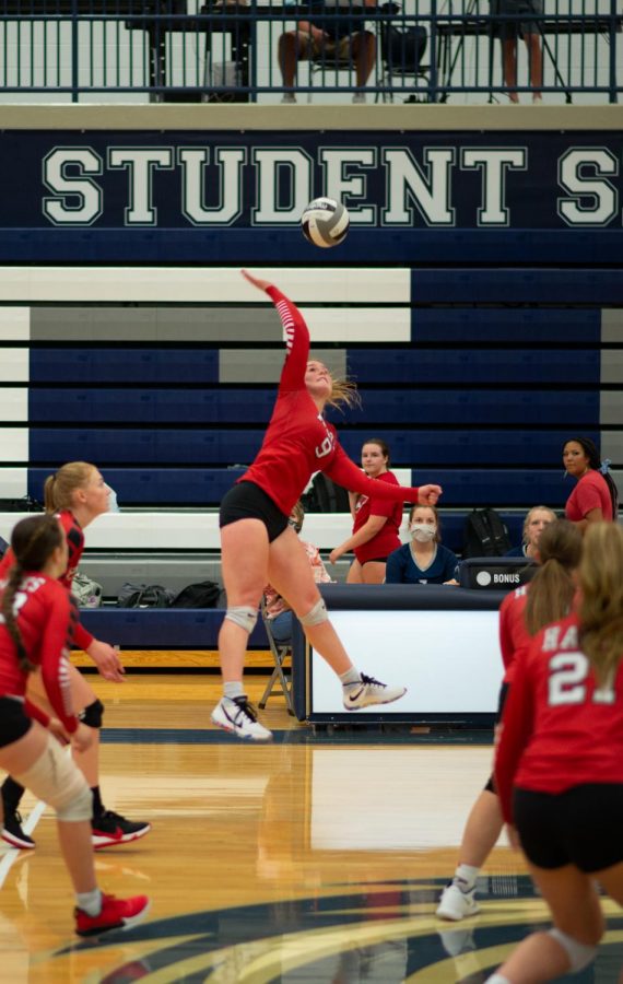 Tenley Derieg soars as she smashes the ball to the other side of the net.