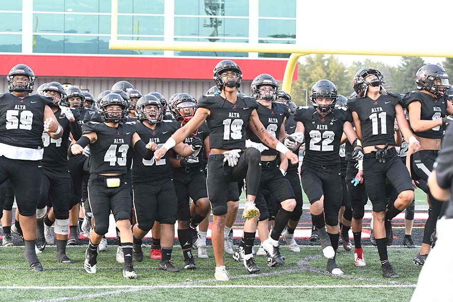 The football team goes through its pre-game ritual to unite as a team and hit the ground running when the whistle blows.