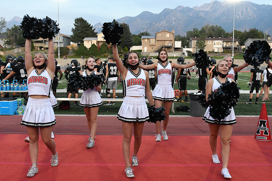 Alta cheerleaders, a fixutre at sports events, excite the crowd at this years Homecoming game. Cheerleading is the most expensive pay to play sport at Alta.