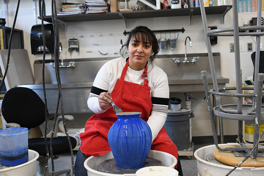 Joahna Lemus works on the potter's wheel in her ceramics class. Joahna's art was accepted into the Utah High School Art Show this month. Three other students also had work accepted into this juried show.