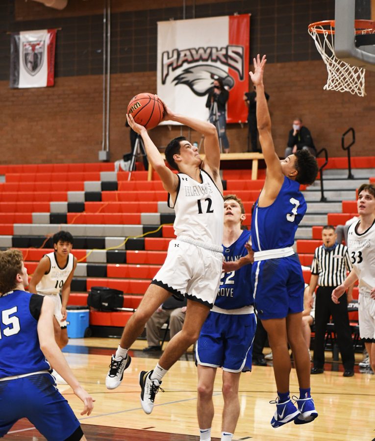 Taking it to the hoop, Junior Jensen Campbell scores two points.