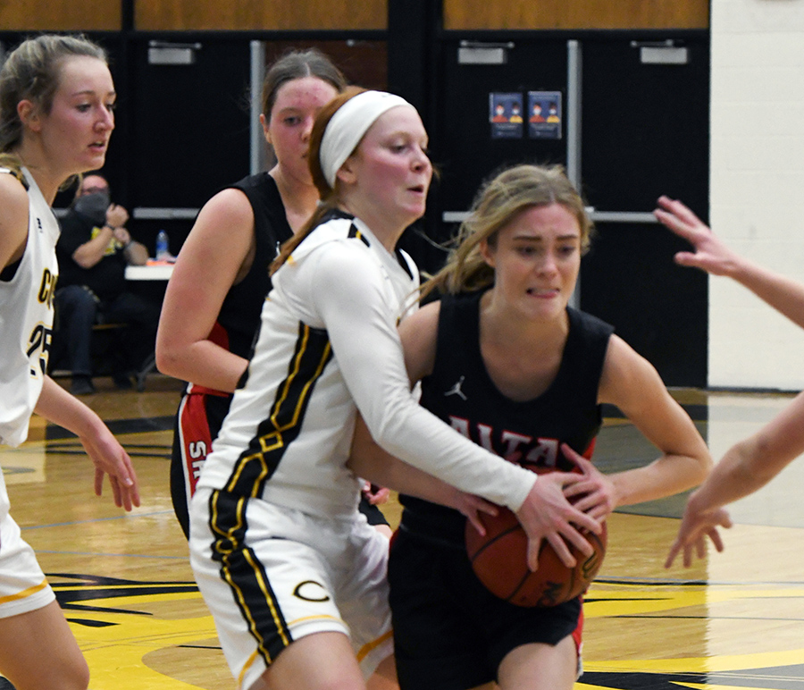 Senior Sadie Strate fends off the opposition on her way to the basket.