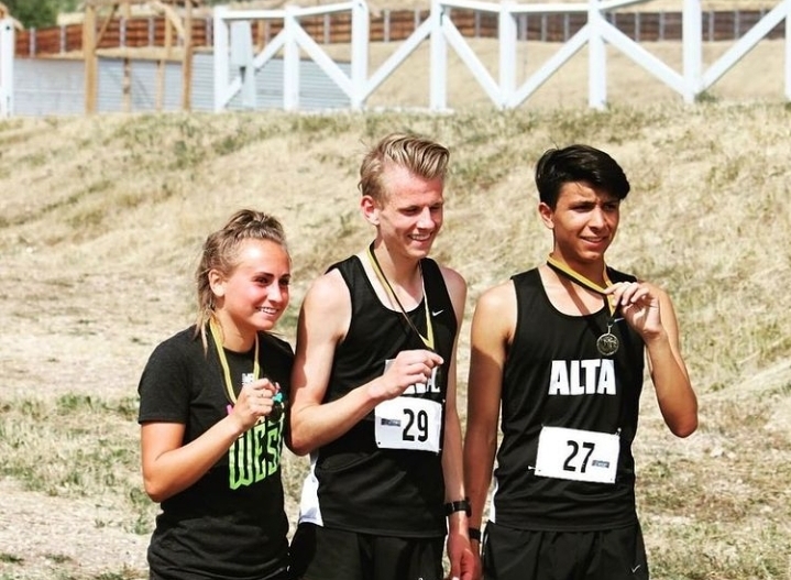AJ Rowland (right) shows off running awards with Ian Valentine and Morgan Jensen in 2019.