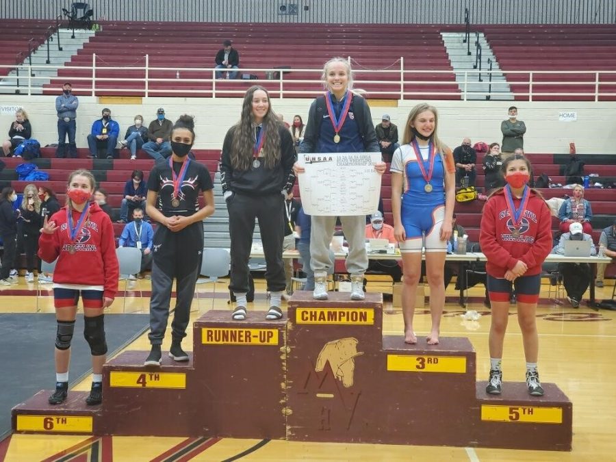 Siarra Sherod, second from the left stands on the podium to receive her fourth place medal for the 110 pound weight division at state competition in Heber City at the end of February.