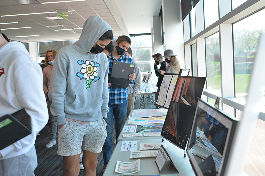 Students wander through this year's student Art Show in the Fieldhouse Gallery.