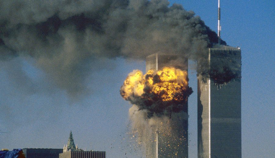 The+World+Trade+Center+south+tower+%28L%29+burst+into+flames+after+being+struck+by+hijacked+United+Airlines+Flight+175+as+the+north+tower+burns+following+an+earlier+attack+by+a+hijacked+airliner+in+New+York+City+September+11%2C+2001.