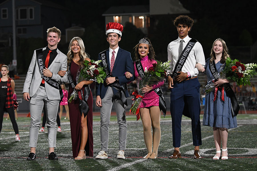 Homecoming royalty Jett Lundberg & Lucy Lesueur, Russell Affleck & Kate Spencer, Maika Kaufusi & Anna Teichert pose for a photo after the royalty presentation at this years Homecoming game against Timpview.