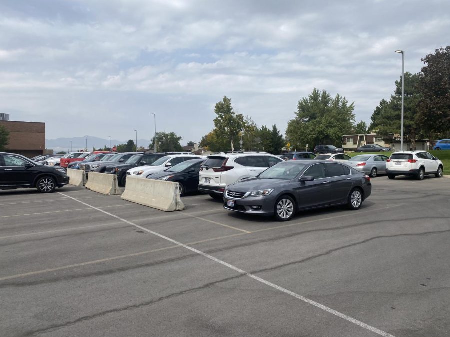 Cement dividers placed in the faculty parking lot section off a new area for student parking.