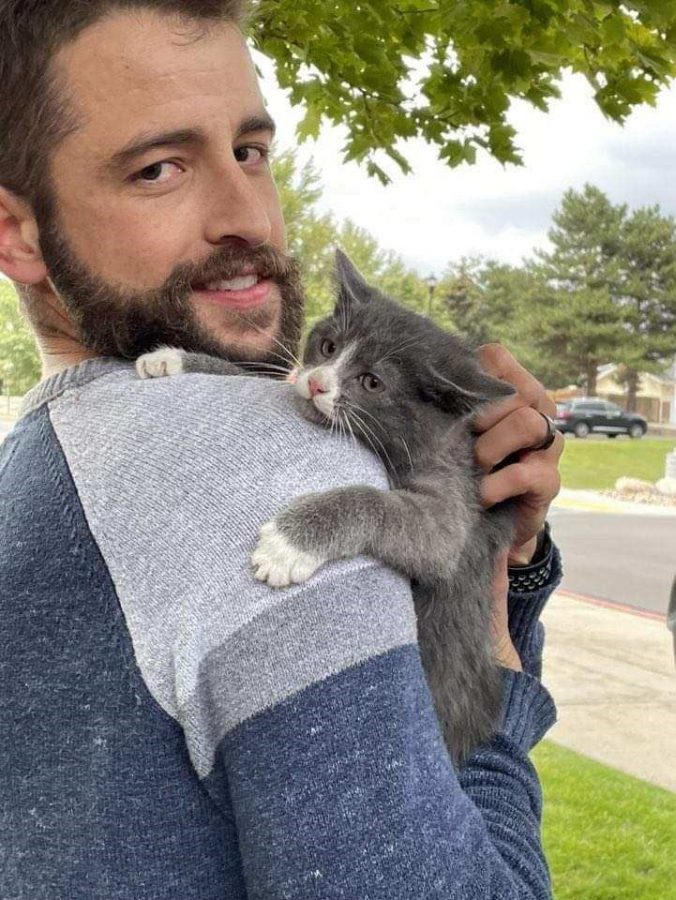 Tired and cold, Gandalf hugs band director Caleb Shabestari after his fortunate rescue during marching band practice.