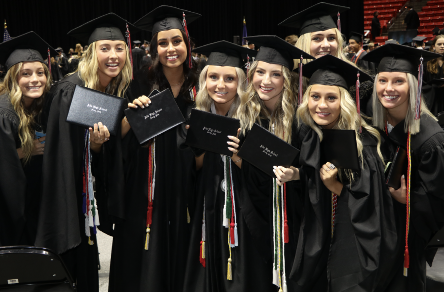 AHS+2021+graduates+pose+with+their+diplomas+following+graduation+at+the+Huntsman+Center+at+the+University+of+Utah.