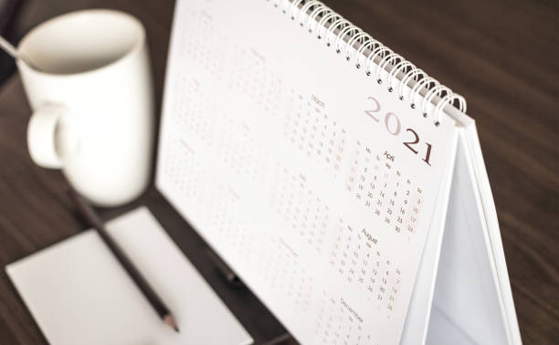 Desktop calendar sitting on desk showing year of 2021