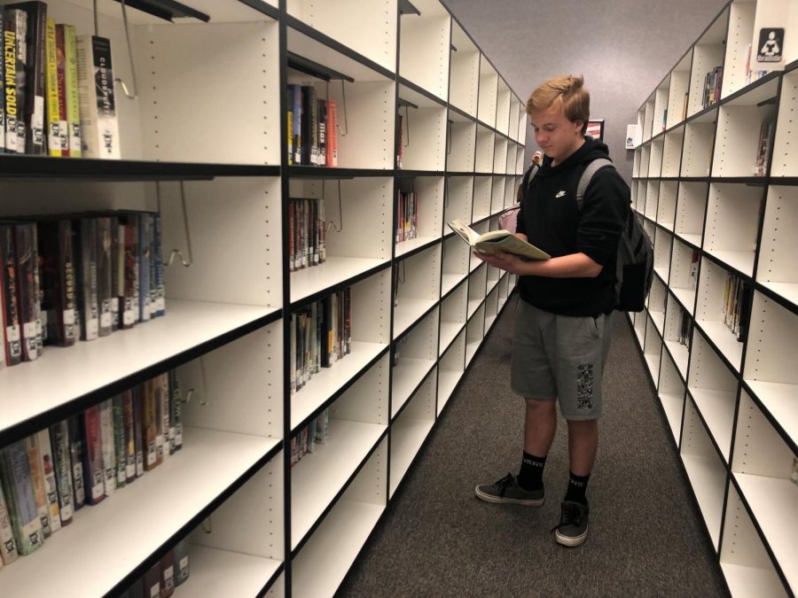 Student Dylan Carney looks at books in the Alta Media Center. The group Utah Parents United is asking the Media Center to pull books they find objectionable.  Students and teachers addressed the board and discouraged censorship of school library materials.