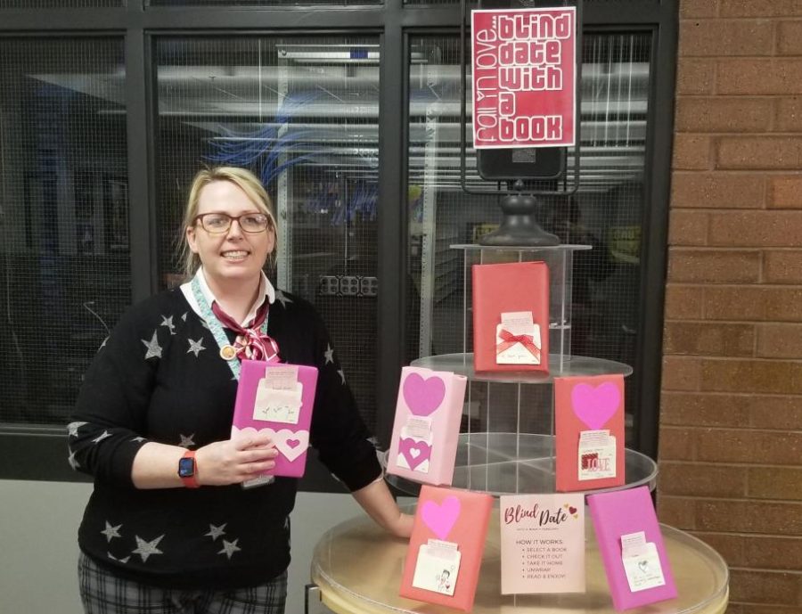 Annelise Xiao shows off the Blind Date with a Book program in Altas library.