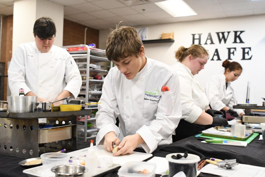 Adam Christiansen preparing food in the ProStart kitchen. 