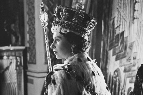 Queen Elizabeth II poses in her coronation attire in the throne room of Buckingham Palace in London, after her coronation on June 2, 1953.