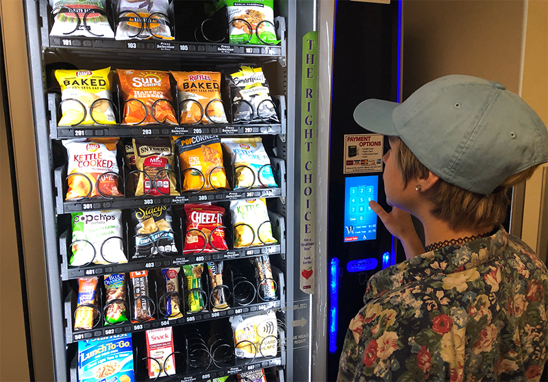student purchasing from the vending machine
