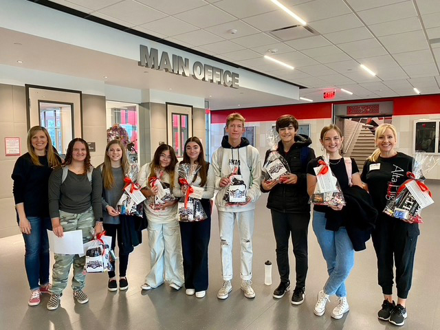 PTSA students and officers prepare to surprise November's Hawk Heroes with gift baskets of goodies.