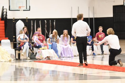 Many princes present flowers to this years Make-a-Wish kid Ellie in the kick off assembly at the end of October.