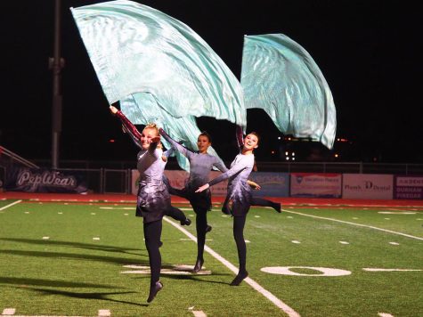 Audrey Farnsworth, Eleana Kent, and Aria Ketner perform their fall show, To A Flame at marching band finals.