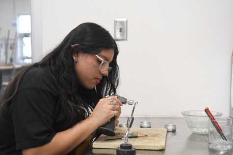 Evelyn Marcial Ramirez creates designs of her own in jewelry class.
