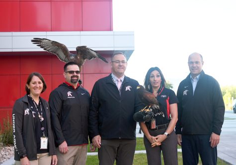 School administrators pose with a hawk at the beginning of the school year. Hawks are confident and helpful!