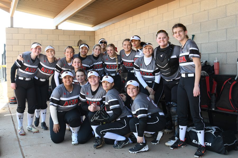 The+girls+softball+team+poses+in+the+dugout+before+their+game+with+Timpanogos+last+week.