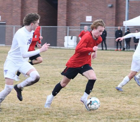 Staying focused, forward Preston Ludlow keeps the ball from his Lehi opponent.
