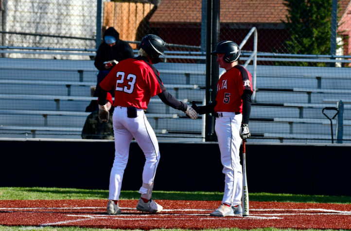 Bentley Croon (Sr) celebrates home run with teammate Jeremy Christiansen (Jr)