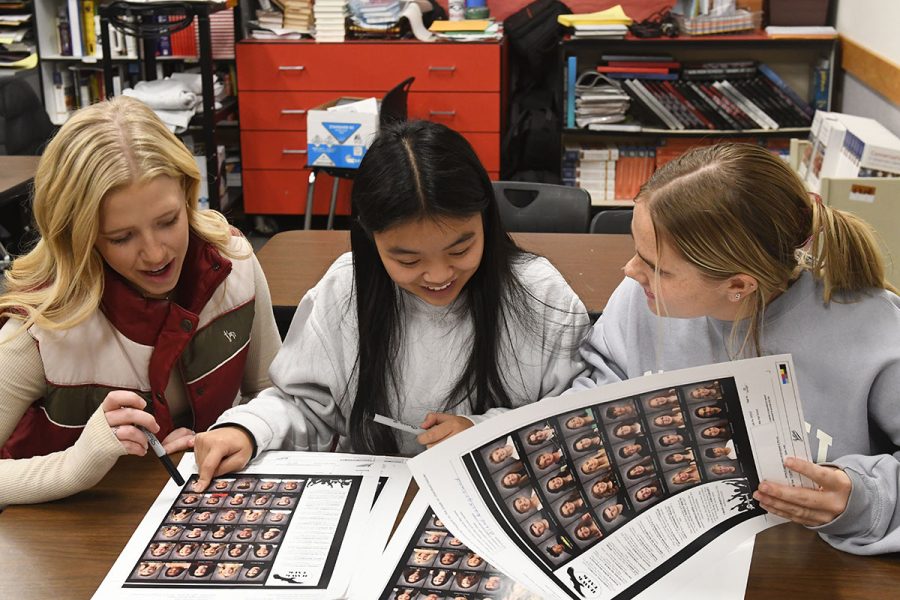 Cali Jeppson, Kimmy Ha, and Kennedy Oviatt edit page proofs on the 2023 yearbook. A limited number of books are still available for purchase in the main office. 